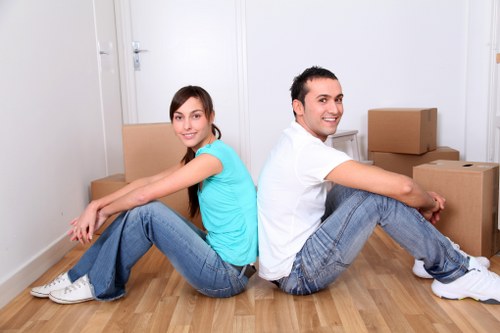 Trained movers carrying furniture through a property safely